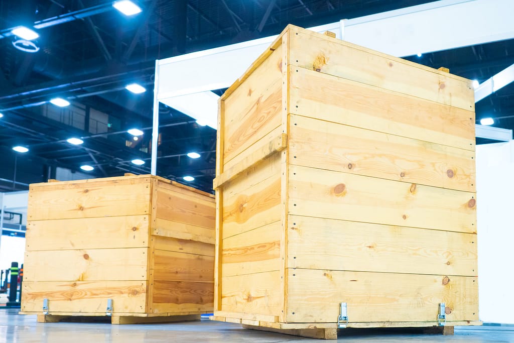 Wooden boxes in the warehouse. Boxes out of wood for packing industrial machinery. Warehousing. Packaging of finished products of the plant. Sale of packaging materials.