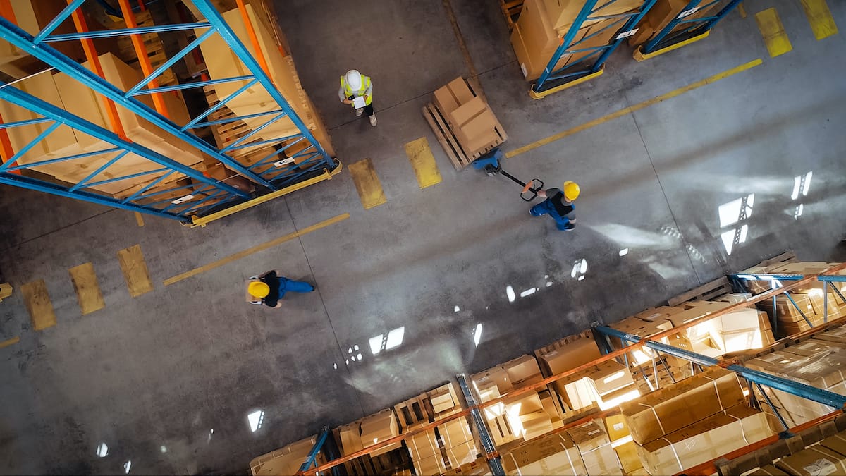 Top-Down View: In Warehouse People Working, Forklift Truck Operator Lifts Pallet with Cardboard Box. Logistics, Distribution Center with Products Ready for Global Shipment, Customer Delivery